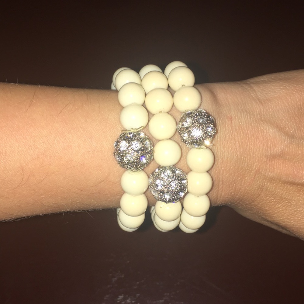 Three cream beaded bracelets.